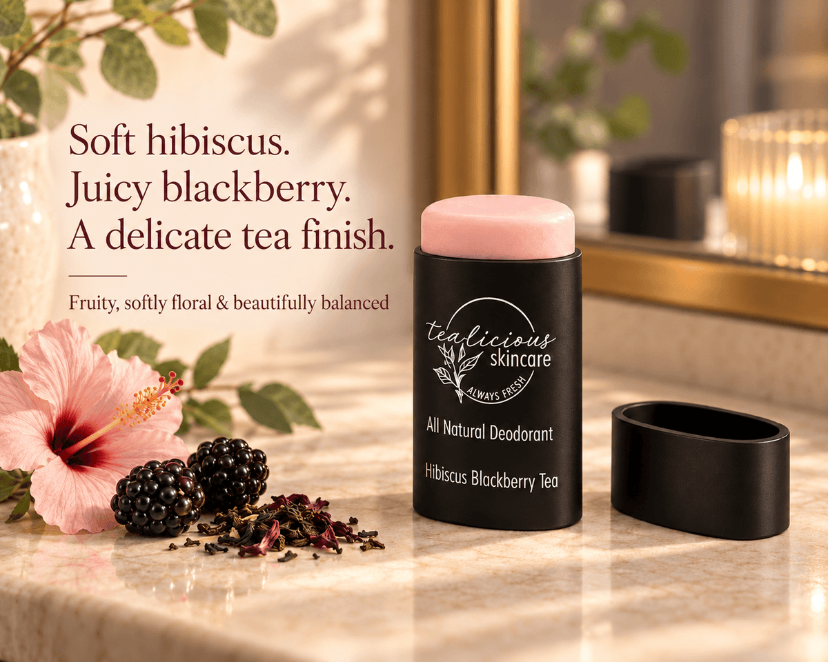 Tea-licious Hibiscus Blackberry Tea deodorant beside a hibiscus flower, blackberries and tea leaves, with text describing its fruity, softly floral scent