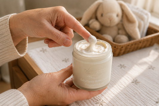 Person applying cream from a jar with a plush toy in the background
