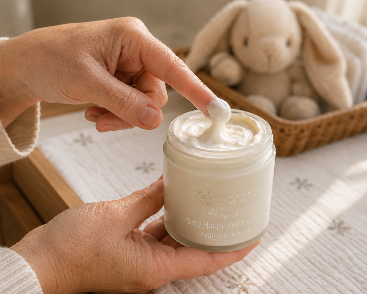 Person applying cream from a jar with a plush toy in the background