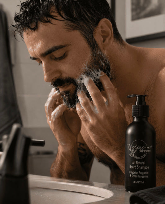 Man using Tea-licious beard shampoo in beard grooming routine with real skin texture in bathroom