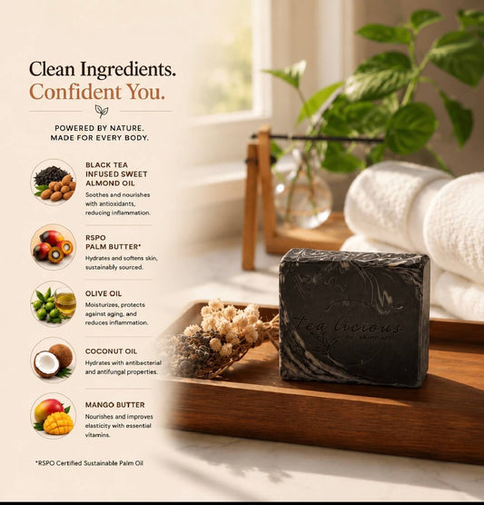 Bar of charcoal soap on a wooden tray with a blurred background of a bathroom.