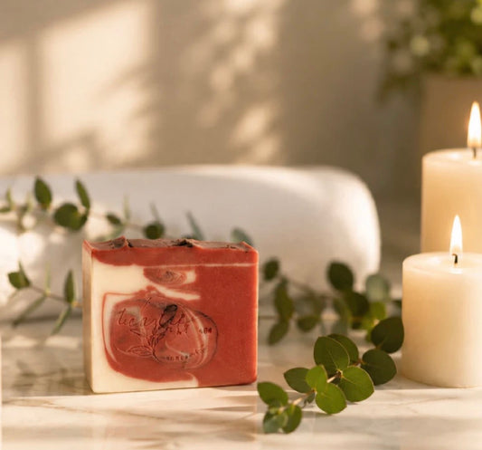 Blackberry Tea & Lavender soap bar with eucalyptus and candles in a warm spa-inspired setting.