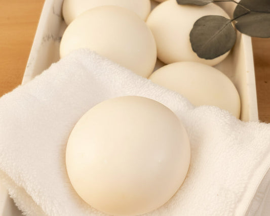 Fragrance-free Tea-licious soap bars displayed on a soft white towel with eucalyptus accents.