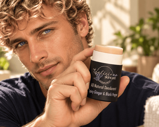 Blond, blue-eyed man holding Tea-Licious Spicy Ginger & Black Pepper natural deodorant in warm natural light.