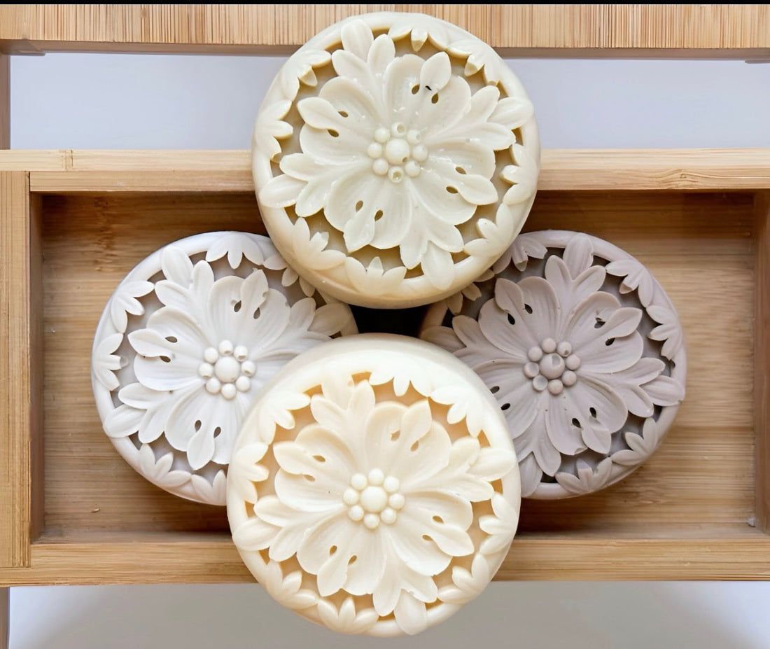 Tea-infused solid lotion bars arranged in bamboo tray showcasing waterless skincare texture details