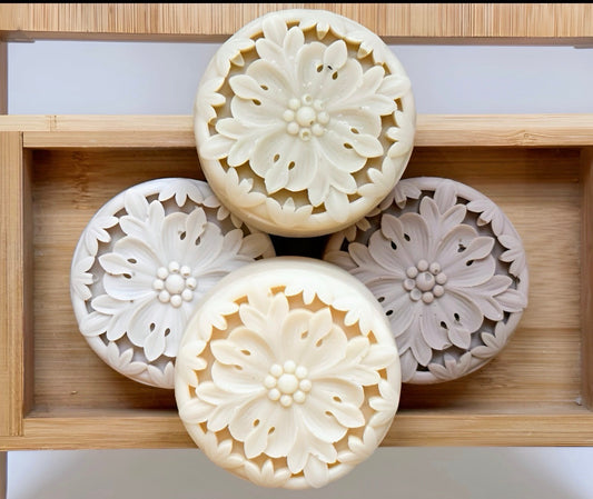 Tea-infused solid lotion bars arranged in bamboo tray showcasing waterless skincare texture details