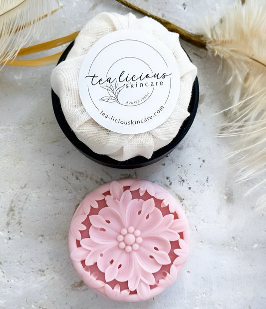 A delightfully intricately molded pink solid lotion bar, featuring rose petal fragrance. 