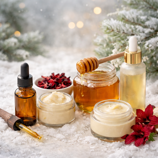 Natural winter skincare ingredients including Manuka honey, hibiscus tea, shea butter, and botanical oils arranged in snow with glass dropper bottles and creamy balms.