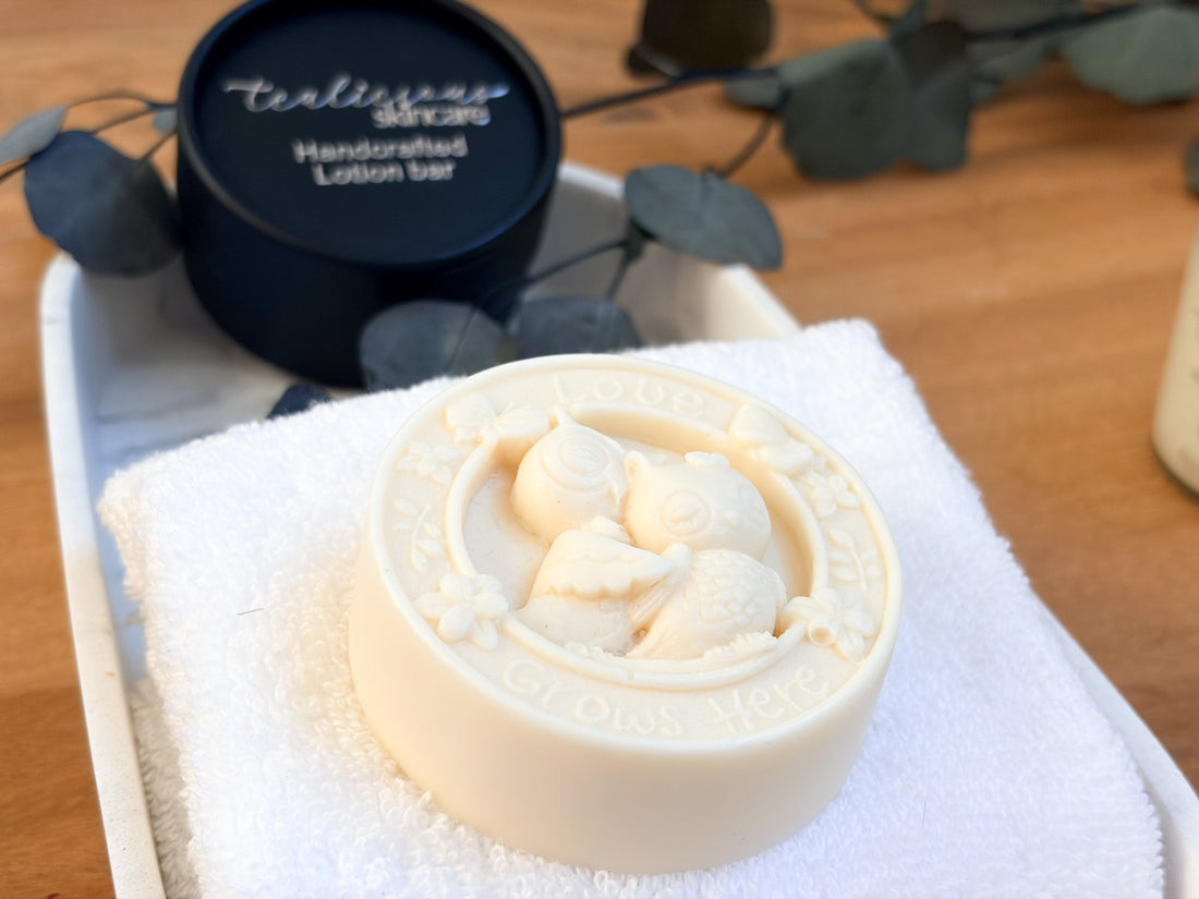 Tea infused solid massage bar with embossed design on towel beside packaging showcasing waterless skincare texture