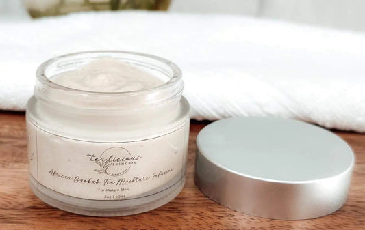 Tea-infused baobab moisture cream in glass jar showing waterless hydration and barrier support.