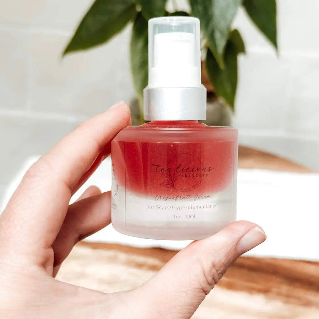 Tea-Licious Dragonfruit Serum in gradient red ombre glass bottle with white pump – targeted for scars and hyperpigmentation, cruelty-free and handcrafted.