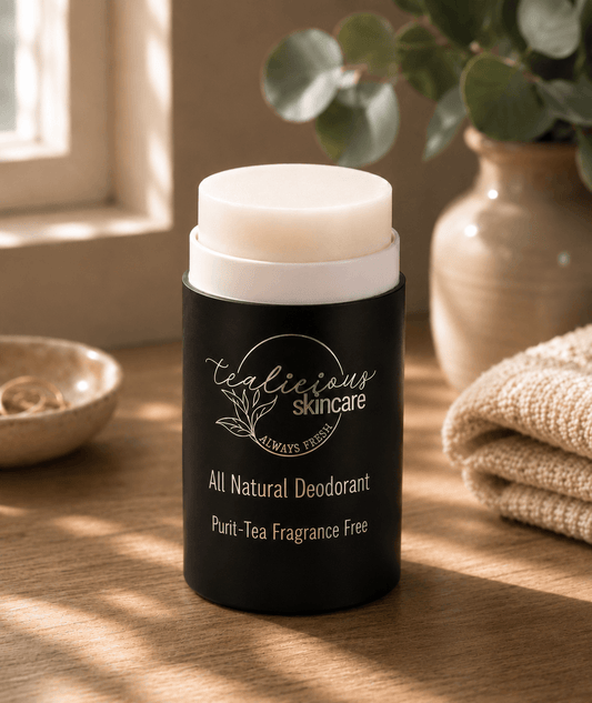 Tea-licious Skincare Fragrance Free Deodorant sitting on a counter with eucalyptus in the background 