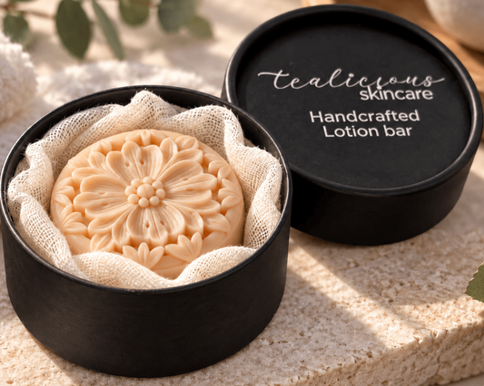 Black tea, Wild Honey & Cashmere Solid Lotion Bar in a black Tea-Licious Skincare container with soft gauze, styled in warm natural light with neutral spa-inspired accents.