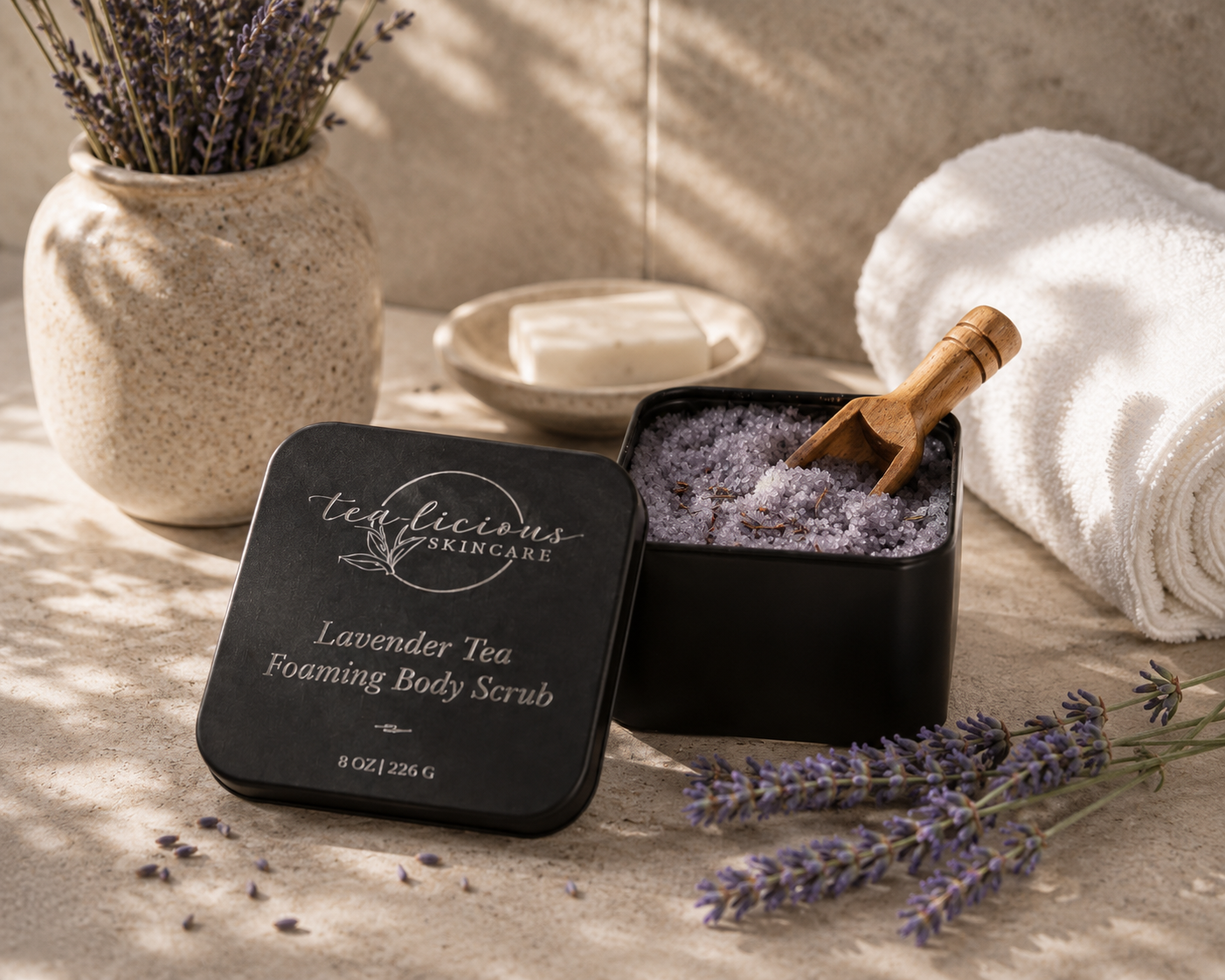 Lavender-tea-foaming-body-scrub-with packaging on a textured surface with lavender flowers.