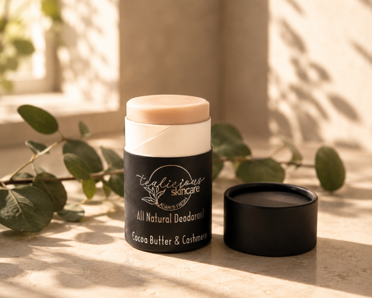 Tea-licious Skincare All Natural Cocoa Butter and Cashmere deodorant stick with an open black cap on a smooth surface, sitting in warm morning sunlight.