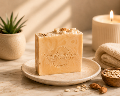 Bar of soap with 'Tealicious Skincare' branding on a plate with a candle and plant in the background.