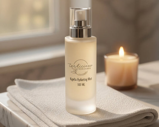 Tea-licious Kigelia Tea Hydrating Mist on spa towel beside candle in elegant bathroom setting