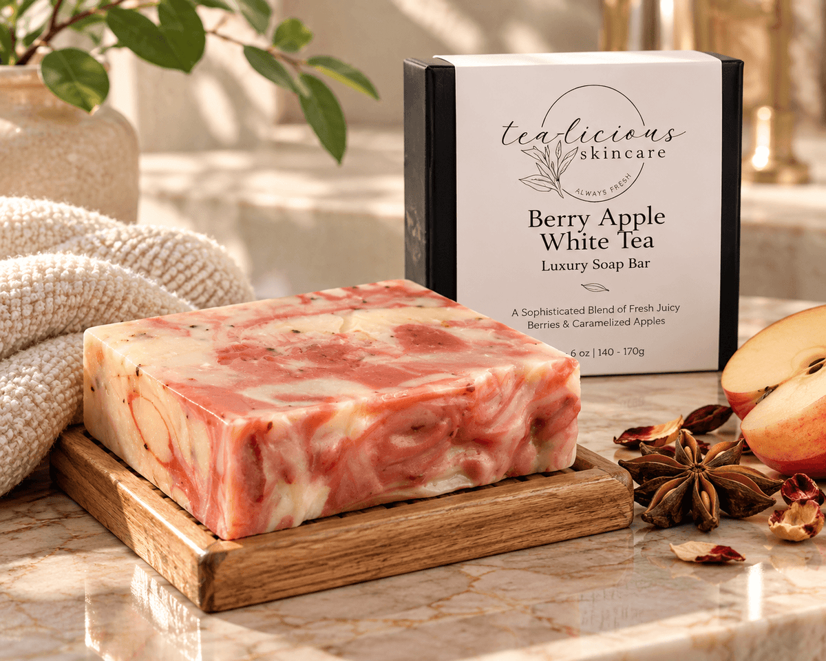 Berry Apple White Tea luxury soap bar with pink and cream swirls, displayed on a wooden soap dish with apple, star anise and its Tea-Licious Skincare box.