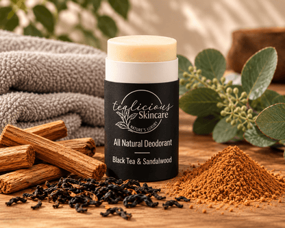     Tea-Licious Black Tea & Sandalwood deodorant with black tea leaves and sandalwood in a warm natural setting.
