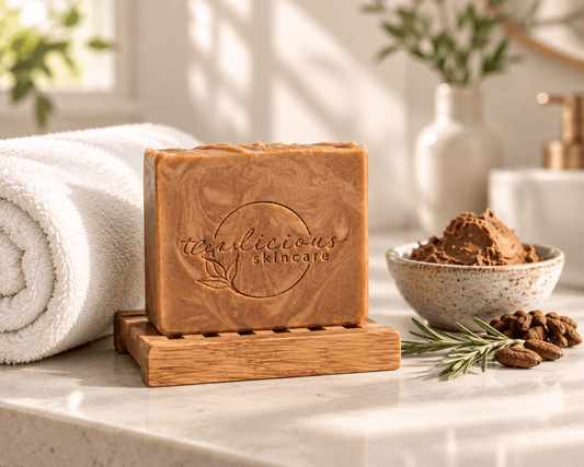 Cashmere & Cocoa Butter handcrafted soap bar displayed on a bamboo rack with cocoa butter and botanical accents.