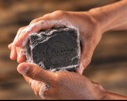 Man holding Tea-Licious Black Tea & Sandalwood men’s soap in wet, lathered hands.