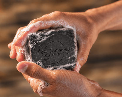 Man holding Tea-Licious Black Tea & Sandalwood men’s soap in wet, lathered hands.