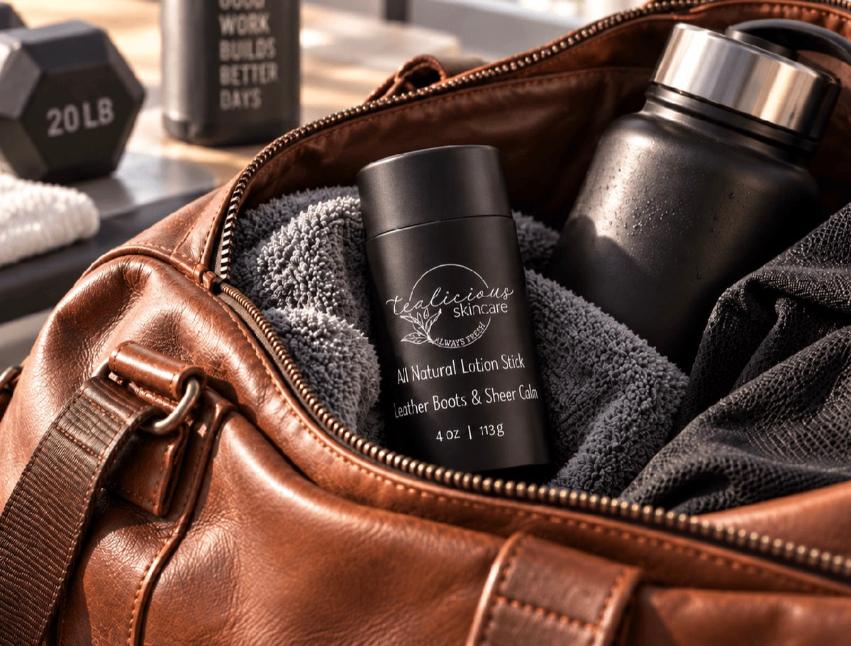 Tea-Licious men’s solid lotion stick with black lid packed in a brown leather gym bag with towel, water bottle, and workout gear.