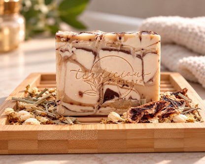 Tea-Licious Rooibos, Amber & Patchouli handcrafted soap with real tea leaves on a bamboo tray.