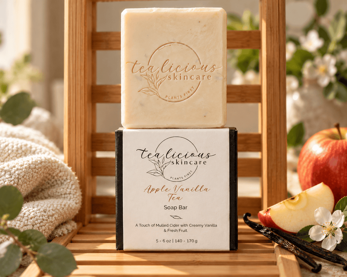 Tea-licious Apple Vanilla Tea Soap Bar displayed on its box on a bamboo shelf beside cream towels, apples and vanilla pods.