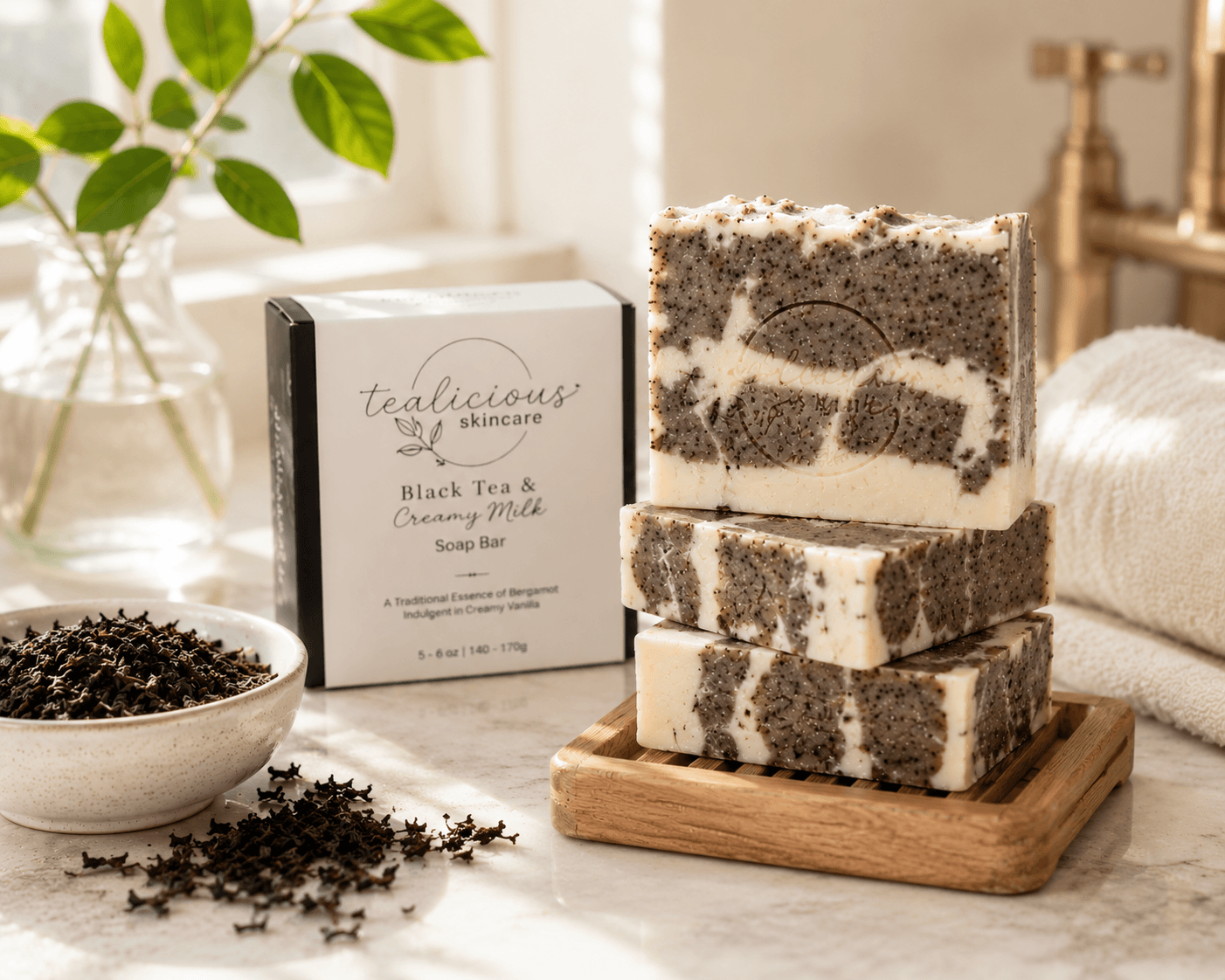 Tea-Licious Black Tea & Creamy Milk tea-infused soap bars stacked on a wooden tray in a bright bathroom with soft natural morning light.