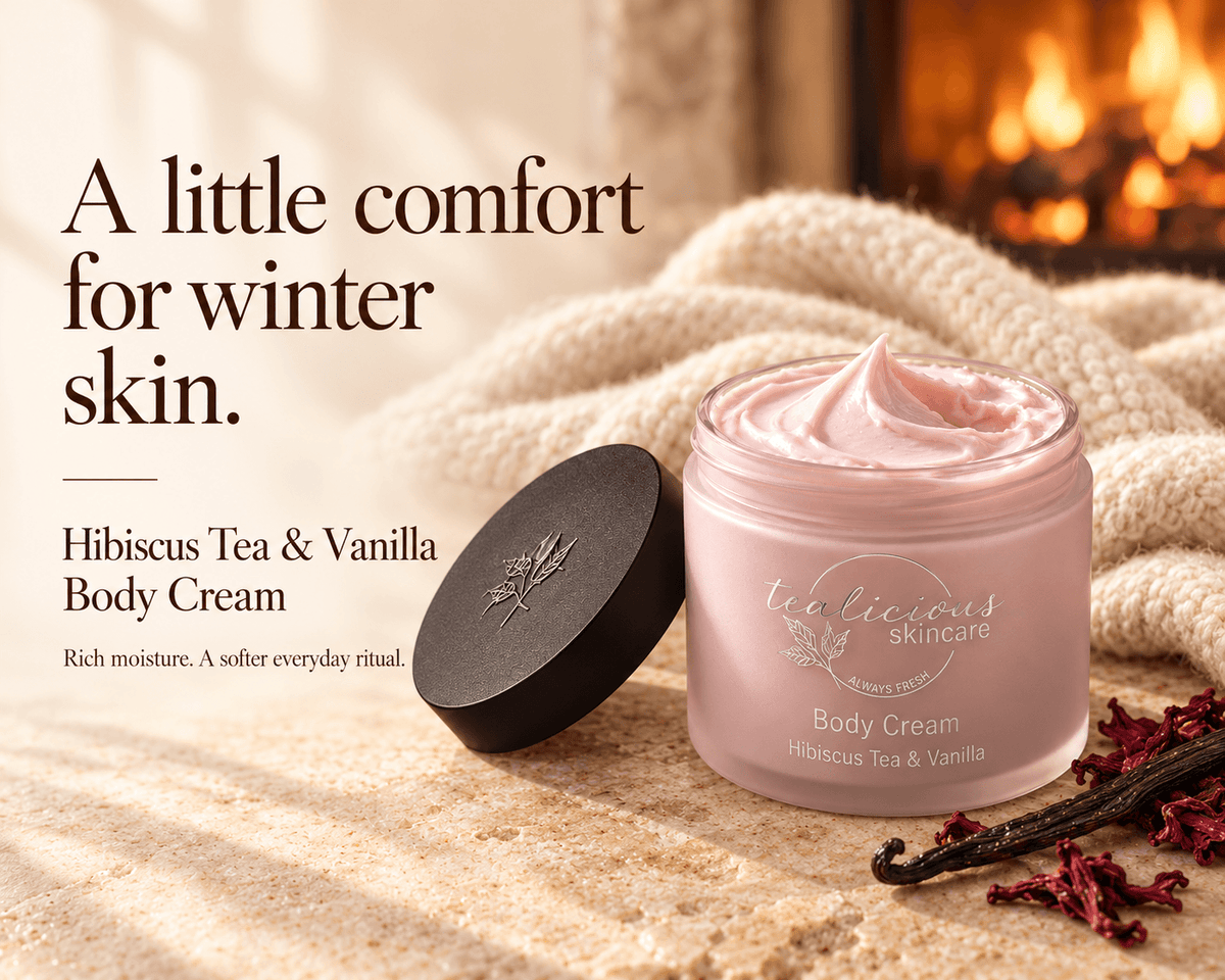Tea-licious Hibiscus Tea & Vanilla Body Cream beside hibiscus petals and vanilla pods, with a fireplace and the headline “A little comfort for winter skin.”