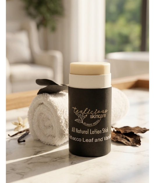 A person applies a Tea-licious Skincare all-natural tobacco leaf and vanilla lotion stick in a bright, modern bathroom setting.