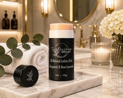 Tea-licious Bergamot Rose Lavender lotion stick on marble tray in upscale spa bathroom setting.