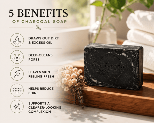Bar of charcoal soap on a wooden tray with text listing benefits, set against a blurred background.