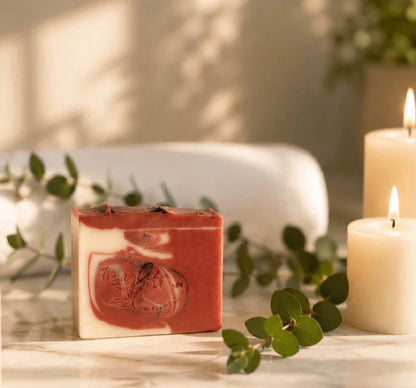 Blackberry Tea & Lavender soap bar with eucalyptus and candles in a warm spa-inspired setting.