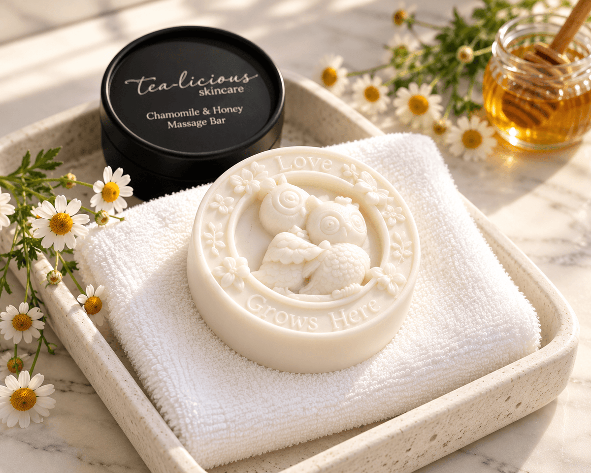 Close-up of the Tea-licious Chamomile & Honey massage bar showing two embossed owls, flowers and “Love Grows Here” lettering.