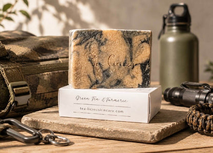 Tea -licious Green Tea and Turmeric soap bar with men’s grooming gear in warm natural sunlight.