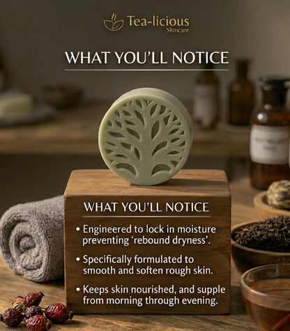 Light sage Tea-licious Skincare men's solid lotion bar sitting on a wooden block featuring product benefits: engineered to lock in moisture, smooths rough skin, and keeps skin nourished all day