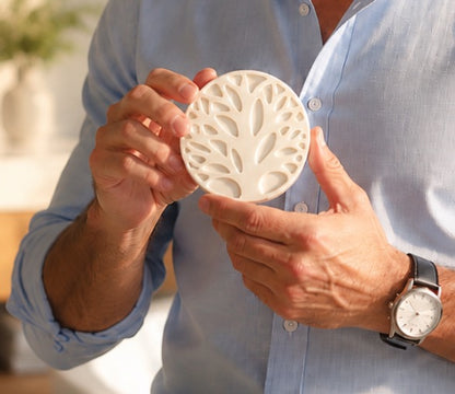 Man holding a Tea-Licious Skincare men’s solid lotion bar, showcasing a waterless black tea infused moisturizer designed to help relieve dry skin and support lasting hydration.