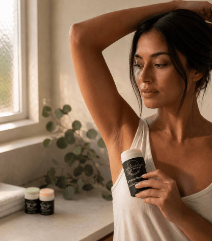 A woman applying Tea-licious Skincare baking soda free deodorant, highlighting natural skin texture.