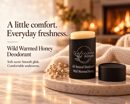 Tea-licious Wild Warmed Honey deodorant on a stone tray beside a cozy knit blanket and fireplace, with the headline “A little comfort. Everyday freshness.”